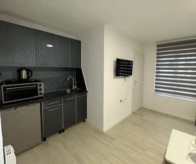 a kitchen with a sink and a stove top oven at Apartman Jasko 2 in Jajce