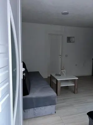 a living room with a bed and a table at Apartman Jasko 2 in Jajce