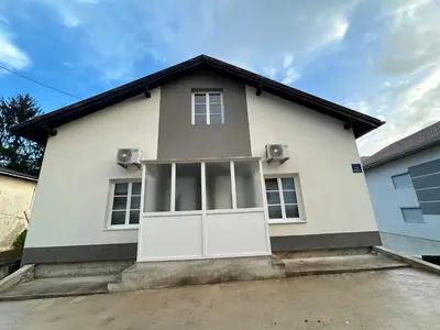 a white house with a large white door at Apartman Jasko 2 in Jajce