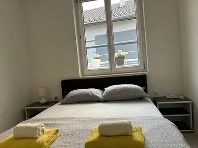 a bedroom with a bed with two pillows and a window at Apartman Jasko 2 in Jajce