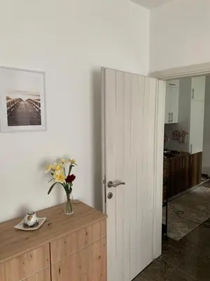 a room with a vase of flowers on a wooden cabinet at Apartment Pahuljica in Travnik
