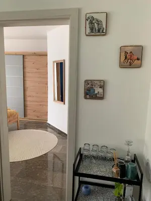a room with a table with glasses on a wall at Apartment Pahuljica in Travnik