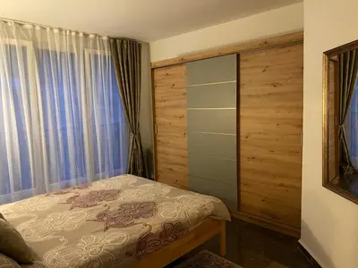 a bedroom with a bed and a large window at Apartment Pahuljica in Travnik