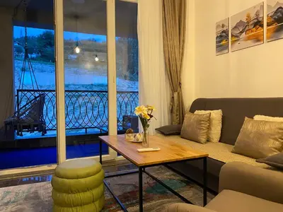 a living room with a couch and a table and a window at Apartment Pahuljica in Travnik