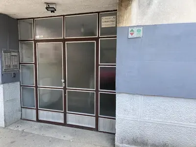 a door to a building with a sign on it at Wonderful apartment in the heart of Tuzla in Tuzla