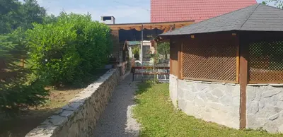 a stone retaining wall next to a house at Green Garden Lohovo in Bihać