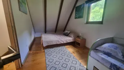 a small room with a bed and a window at Green Garden Lohovo in Bihać