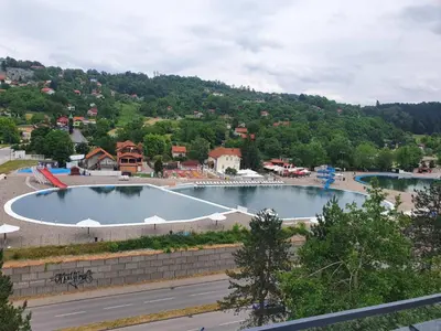a large swimming pool in the middle of a city at apartman Kami in Tuzla