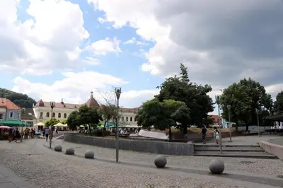 a street in a town with people walking and buildings at apartman Kami in Tuzla