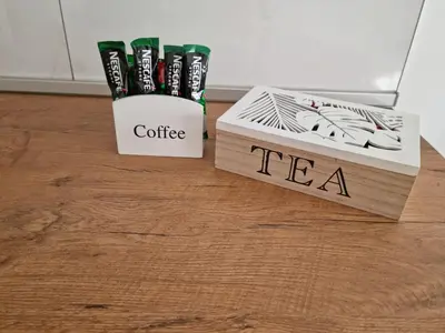 a box of coffee and a box of tea at apartman Kami in Tuzla