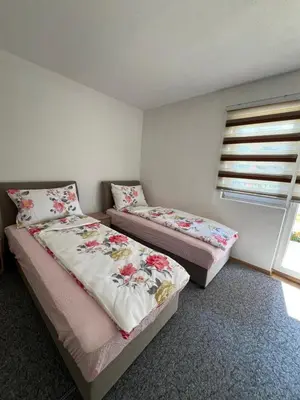 a bedroom with two beds and a window at Weekend house & apartments Dubrave in Visoko