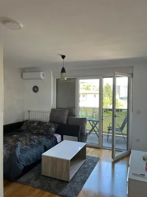 a living room with a couch and a coffee table at Apartman gavric in Doboj