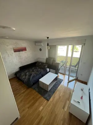 a room with a bed and a couch and a table at Apartman gavric in Doboj