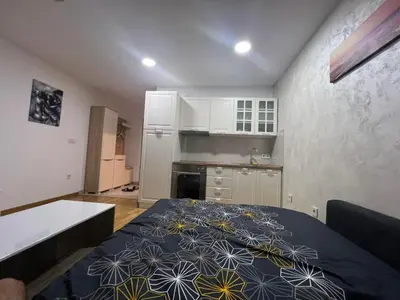 a small kitchen with a bed in a room at Apartman gavric in Doboj
