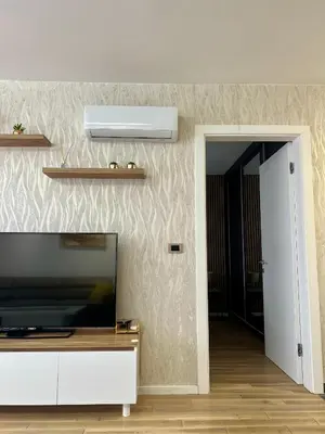 a living room with a flat screen tv on a wall at Emma Park Lake in Tuzla