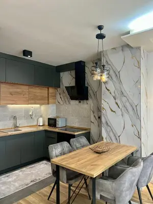 a kitchen with a wooden table and chairs at Emma Park Lake in Tuzla