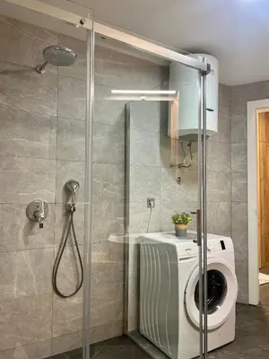a shower with a washing machine in a bathroom at Emma Park Lake in Tuzla