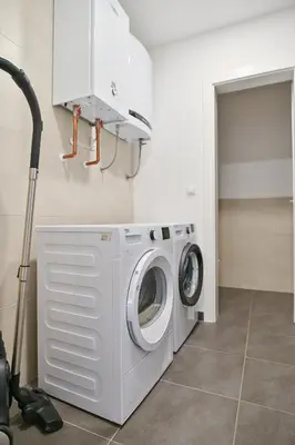 a washer and dryer in a laundry room at Beautiful modern apartment with large livingroom in Bihać