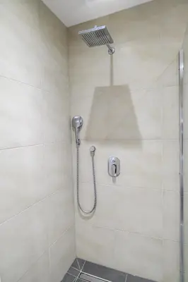 a shower with a shower head in a bathroom at Beautiful modern apartment with large livingroom in Bihać