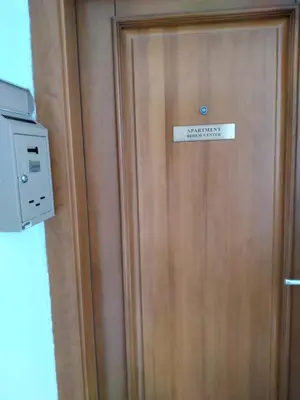 a sign on the door of a hotel room at Apartment Bedem Center in Bihać