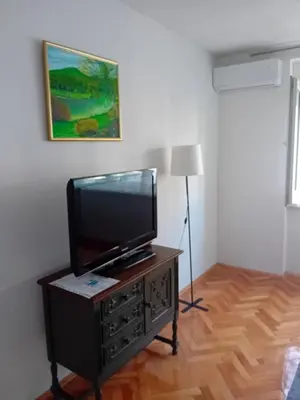 a flat screen tv sitting on top of a dresser at Apartment Bedem Center in Bihać