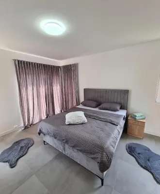 a bedroom with a bed with two pillows on it at Apartmani Bugojno in Bugojno