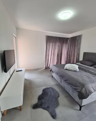 a bedroom with a bed and a flat screen tv at Apartmani Bugojno in Bugojno