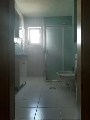 a bathroom with a shower and a toilet and a sink at Apartman Sali in Bihać