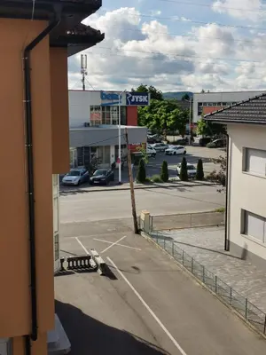 a street sign on a pole in a parking lot at Apartman Sali in Bihać