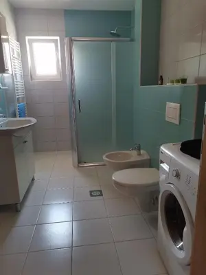 a bathroom with a shower and a toilet and a sink at Apartman Sali in Bihać