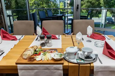 a wooden table with a plate of food on it at Verdi Rooms in Visoko