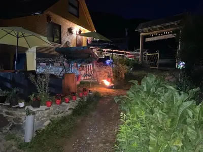 a backyard at night with a garden with plants at Prokoško jezero Zlatna koliba in Fojnica