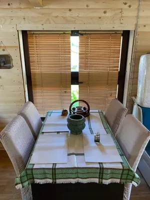 a dining room table with chairs and a tableablish at Prokoško jezero Zlatna koliba in Fojnica