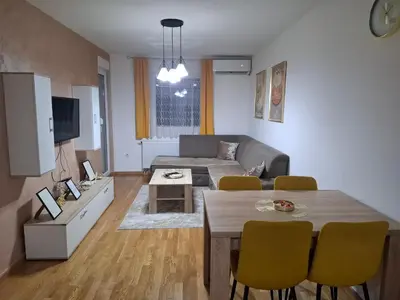 a living room with a couch and a table at Apartman Bulevar in Doboj