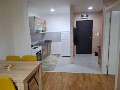 a kitchen with a table and yellow chairs in a room at Apartman Bulevar in Doboj