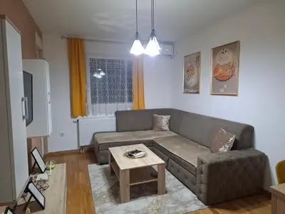 a living room with a couch and a table at Apartman Bulevar in Doboj