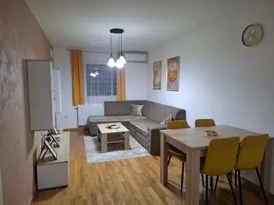 a living room with a couch and a table at Apartman Bulevar in Doboj