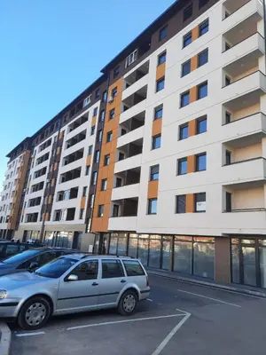 a car parked in a parking lot in front of a building at Apartman Bulevar in Doboj