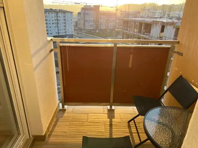 a balcony with a table and chairs on a building at Apartman Gavric in Doboj