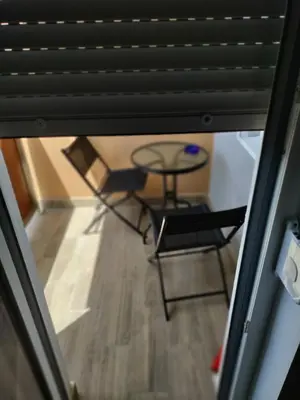 a view of a table and a chair in a room at Apartman Gavric in Doboj
