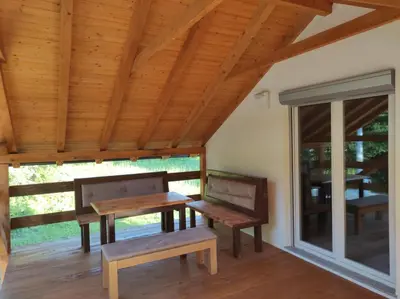 a room with two benches and a table and a window at Holiday home Una - H in Bosanska Krupa