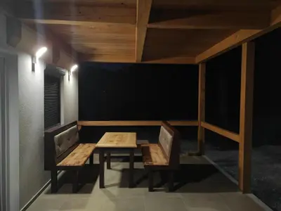 a table and two chairs in a room with a black wall at Holiday home Una - H in Bosanska Krupa