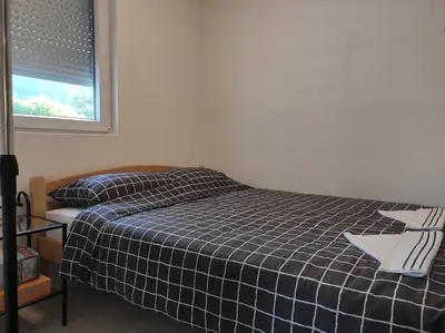 a bedroom with a bed with a blue and white plaid blanket at Holiday home Una - H in Bosanska Krupa