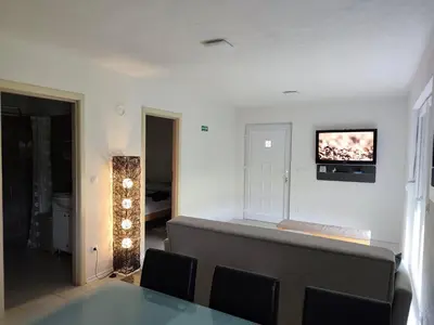 a living room with a couch and a tv on the wall at Holiday home Una - H in Bosanska Krupa