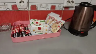 a lunch box with food and a tea kettle on a counter at Apartmani Sarah Tuzla in Tuzla