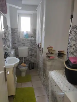 a bathroom with a toilet and a sink at Apartmani Sarah Tuzla in Tuzla