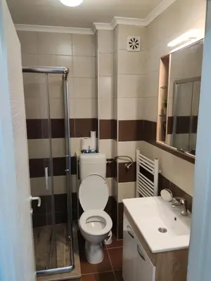 a bathroom with a toilet and a sink at Apartmani Sarah 2 Tuzla in Tuzla