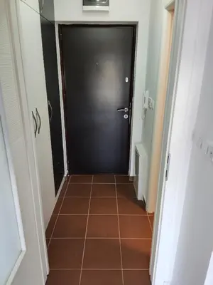 a black door in a hallway with a tile floor at Apartmani Sarah 2 Tuzla in Tuzla