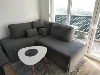 a living room with a couch and a table at Apartmani Sarah 2 Tuzla in Tuzla
