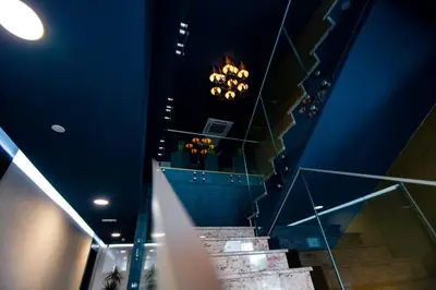 a staircase in a building with lights on the ceiling at HOTEL LOBBY in Bihać